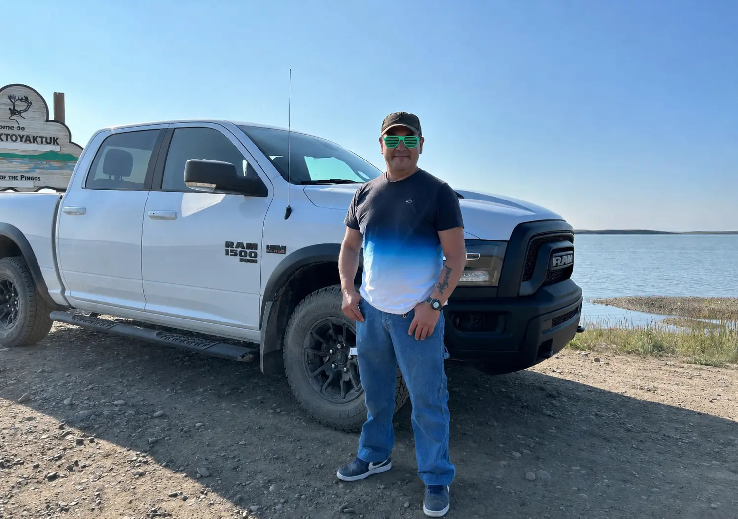 A customer with a white Ram 1500 at the Tuktoyaktuk shoreline