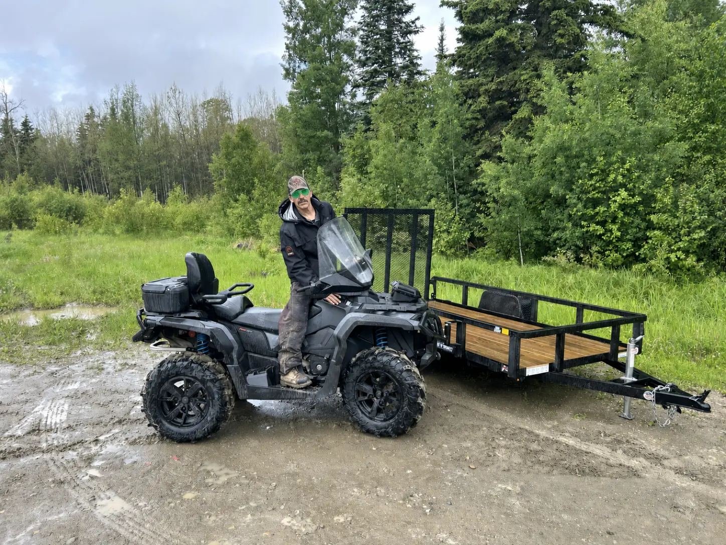 A customer on an ATV with a matching utility trailer