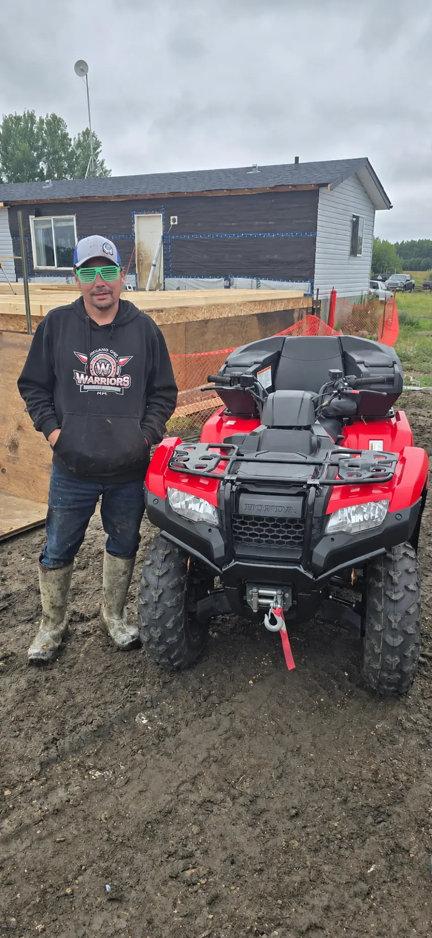 A customer with a red ATV delivered at a job site