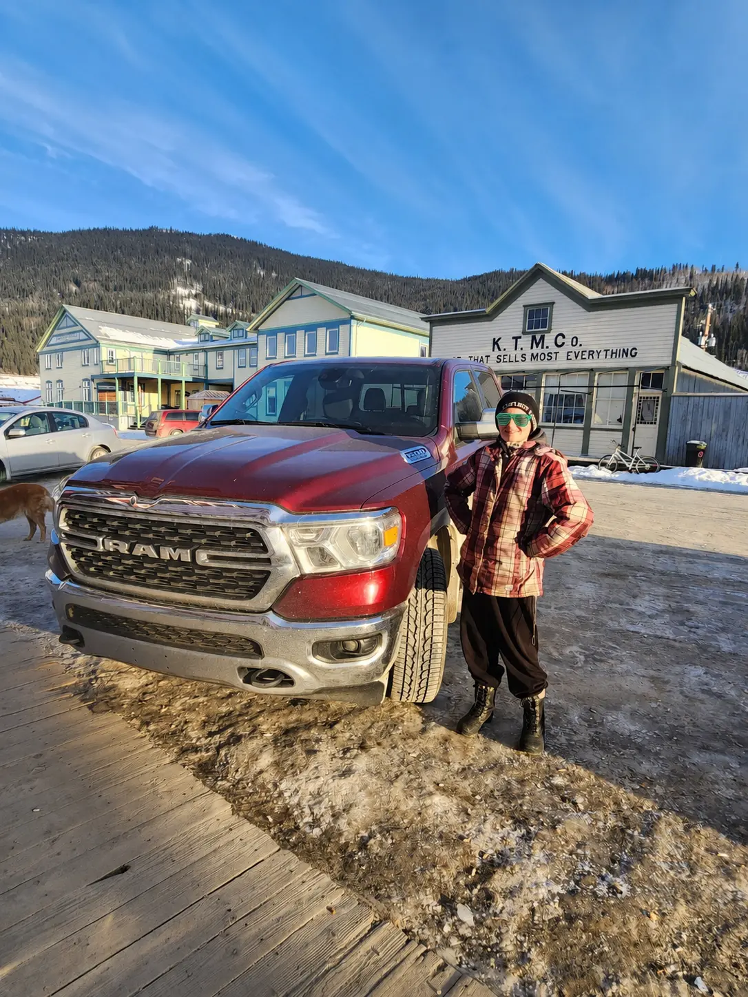 A customer with a red Ram truck outside a small-town general store in winter