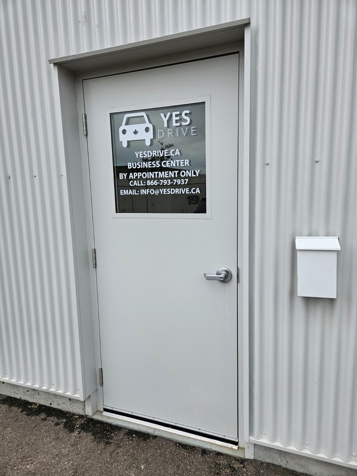 The Yes Drive business centre door with contact details on the glass